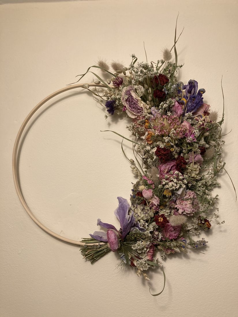 A dried flower half-hoop wreath