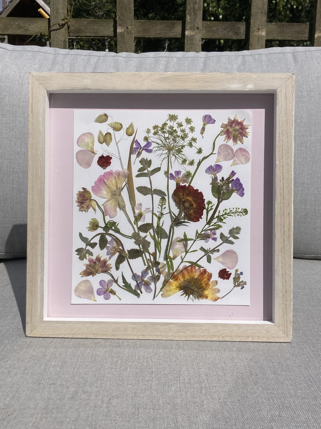 Pressed wedding flowers arranged and framed as a keepsake